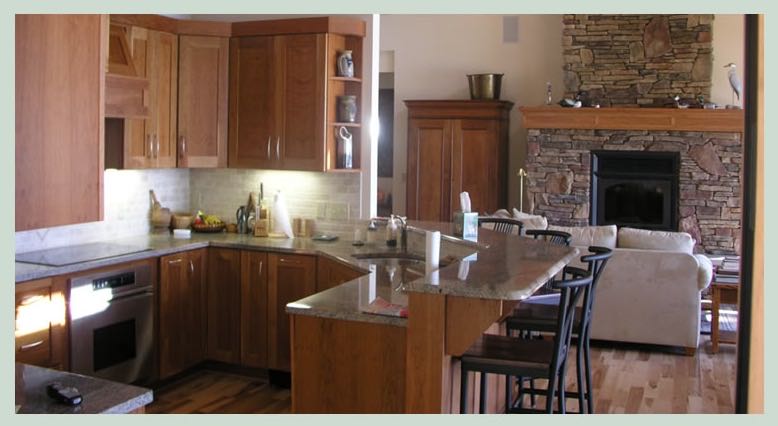 Kitchen with wood cabinets and stone fireplace